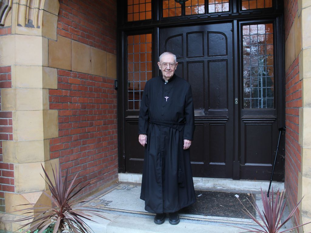 Brother Clement recreates the photo on the steps of Iona House in 2020.